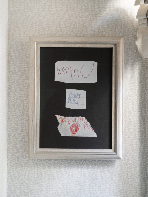 Framed kids handwriting shows three different times my kids wrote 'Mommy.' Framed in rustic white wood frame on a gray matte background.