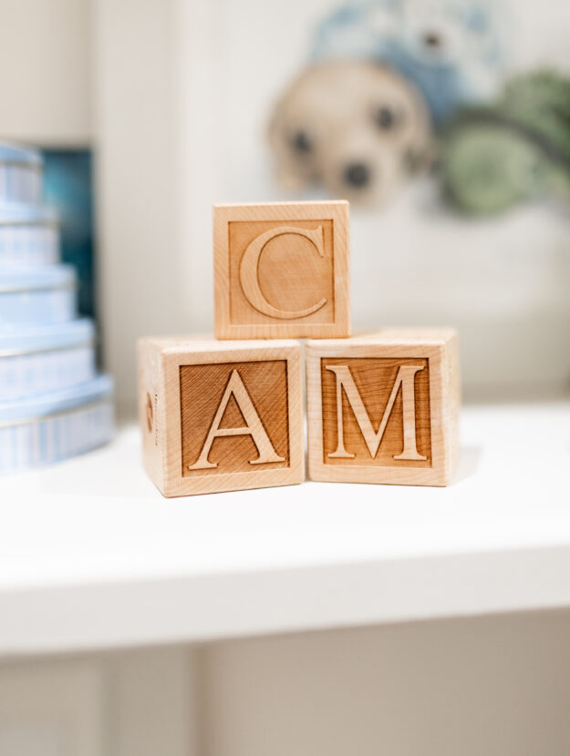 A baby birth detail keepsake stack of 3 wood baby blocks that are personalized with the initials C, A and M.